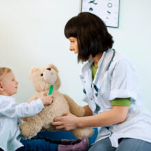 pediatrician-playing-with-child-doctors-office